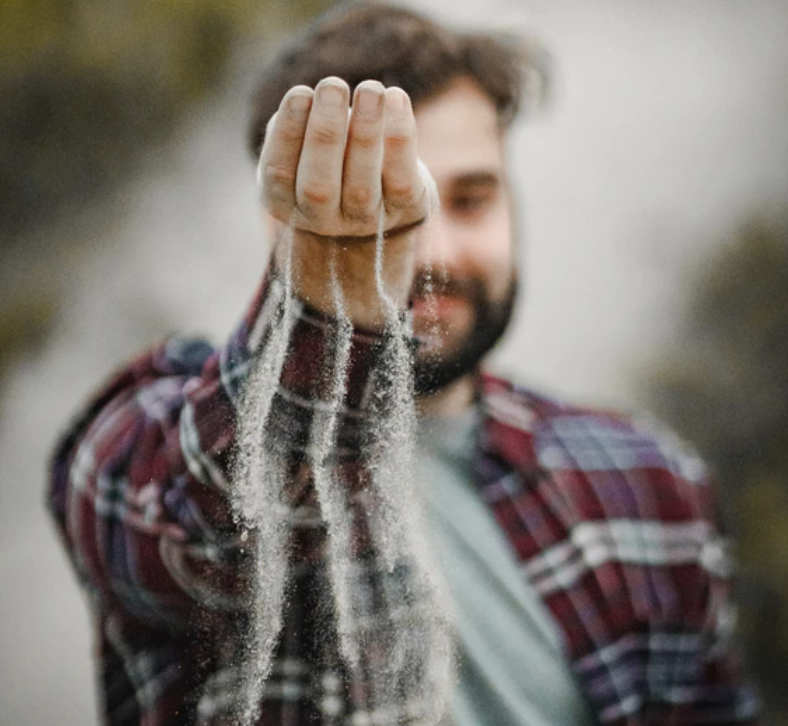 man holding sand